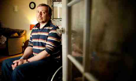 Former Lance Corporal Adam Douglas who has had 20 operations on his spleen and spine after twice being wounded by grenade attacks in Iraq says he is being accused of faking his injuries by the DWP Photograph: Christopher Thomond for the Guardian