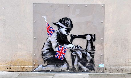 The graffiti, titled 'Banksy Slave Labor (Bunting Boy). London 2012', as it was on the side of Poundland store in Wood Green, London. Photograph: Matthew Chattle/Alamy