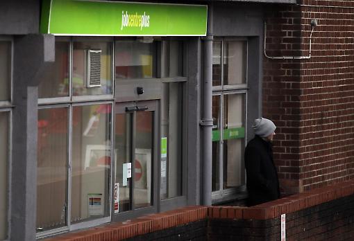 A man stands outside the Jobcentre Plus on January 18, 2012 in Trowbridge, England. Photograph: Getty Images.