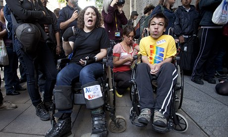Protesters demonstrate against Atos's involvement in tests for incapacity benefits. Photograph: Neil Hall/Reuters