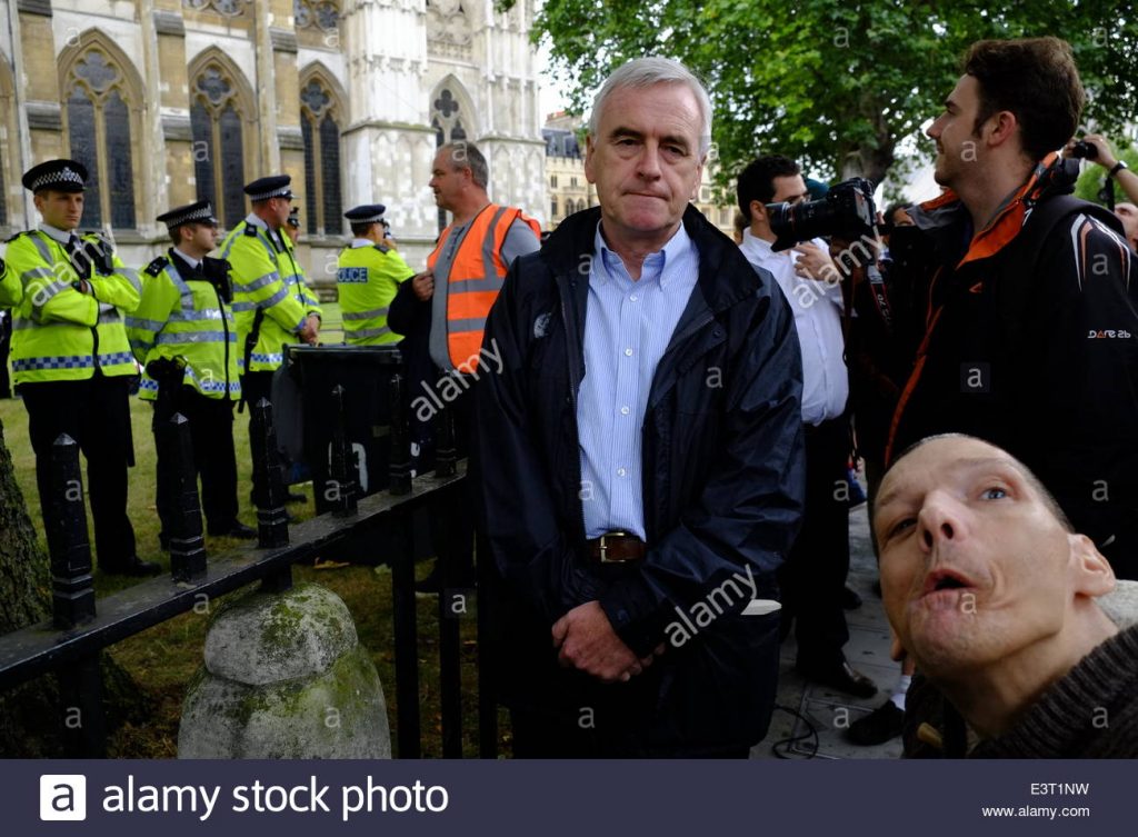 Disabled People Against Cuts (DPAC) stage a protest outside Westminster Abbey on 28th June 2015 to save the Independent Living Fund ILF. The now Shadow Chancellor John McDonnell MP joined them and protected them from heavy-handed policing by the London Metropolitan Police